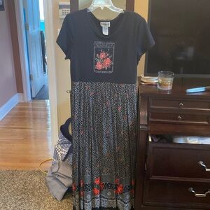 Black Jersey dress with shoulder pads and accordion pleated bottom. Size 16